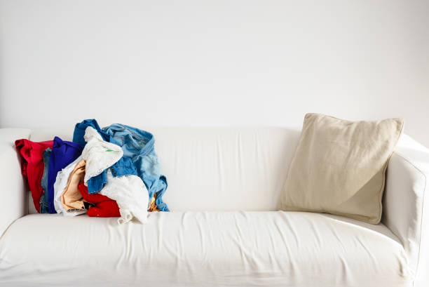 istock Heap of colorful clothing on sofa 838490212