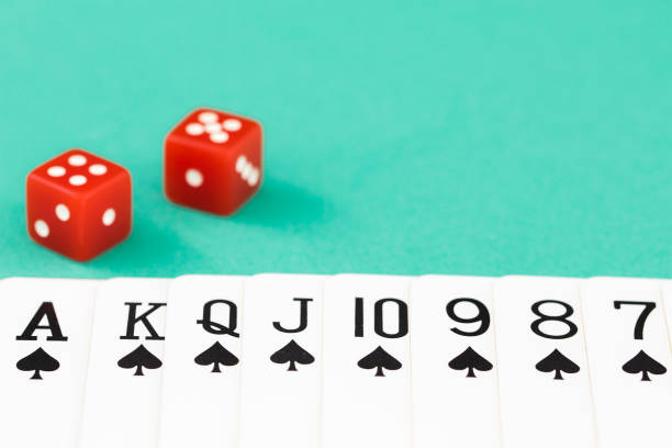 istock Dices and cards on green casino table 838490780