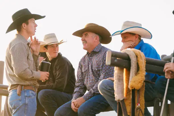 Photo of Group of cowboys sat around chatting