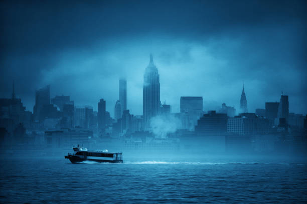 Midtown Manhattan skyscrapers and boat in fog in New York City