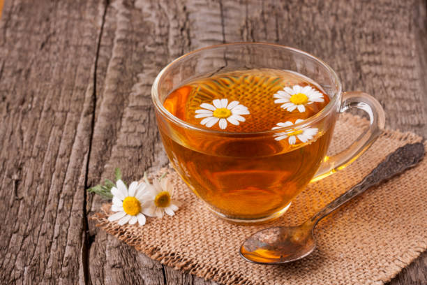 istock Herbal tea with fresh chamomile flowers on old wooden background 838497318