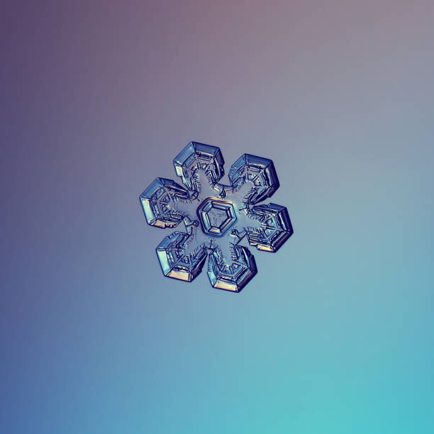 Snowflake glittering on smooth gradient background stock photo
