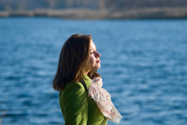 istock Thoughtful girl in a coat on the Water 838498946