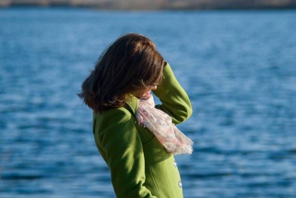 istock Thoughtful girl in a coat on the Water 838498956