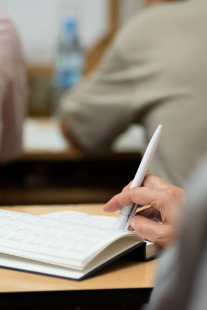 istock Close-up of a female hand with a pen. 838499086