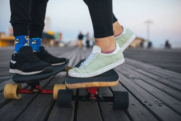 istock Boy and girl feet on long board 838499482