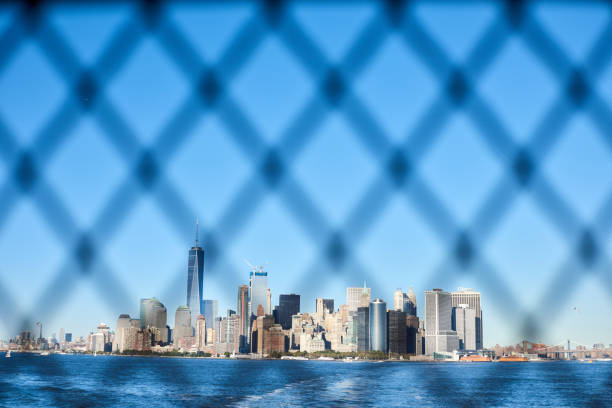 Skyline Manhattan view through the fence from ferry