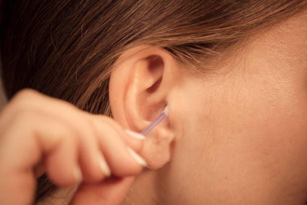 istock Woman cleaning ear with cotton swabs closeup 838499892