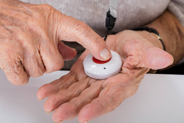 Senior Woman Pressing Alarm Button Close-up Of Senior Woman Pressing Alarm Button For Emergency medical alarm stock pictures, royalty-free photos & images