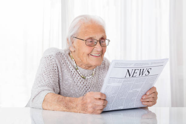 istock Senior Woman Reading Newspaper 838500434