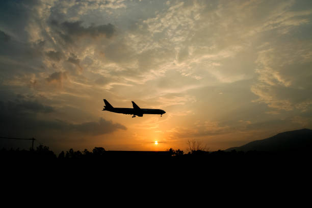istock Airplane Landing with Yellow sky sunset background 838501654