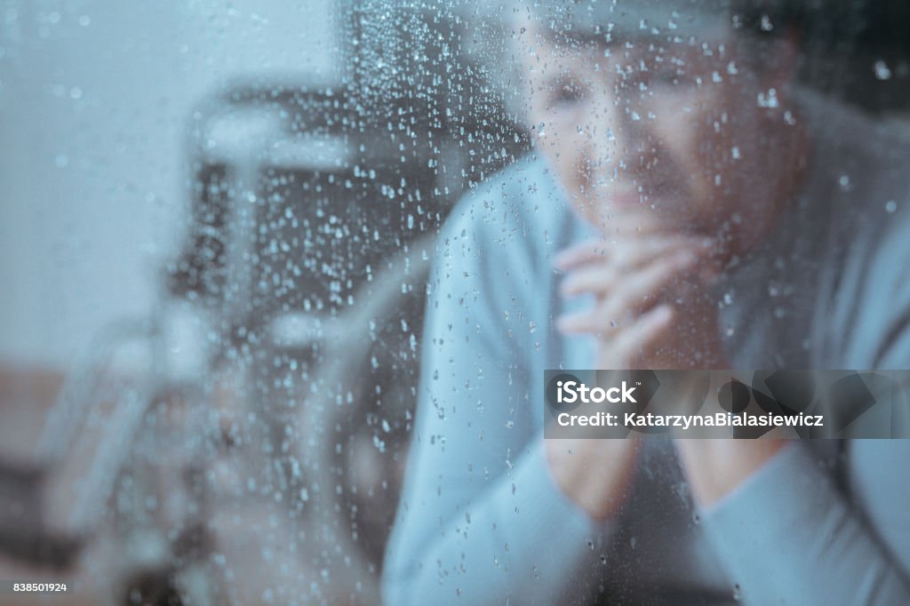 Elder lady sitting Elder lady with depression sitting alone in the room Senior Adult Stock Photo