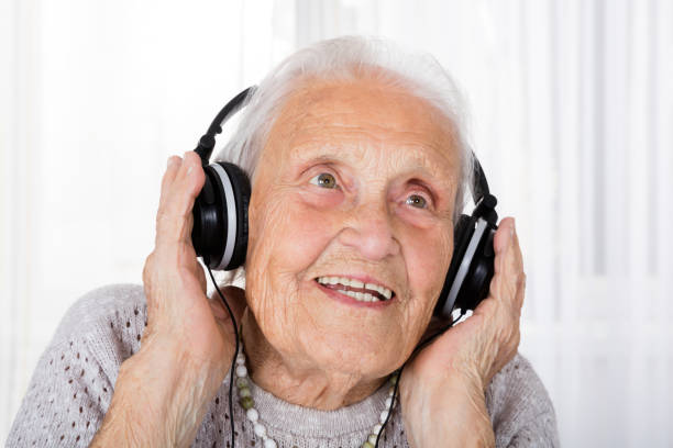 istock Senior Woman Using Headphone At Home 838501998