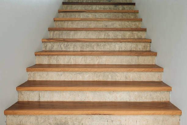 istock Wood staircase on concrete and white wall. 838503986