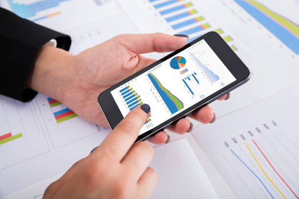 istock Businesswoman Analyzing Financial Graphs Using Smartphone 838506010