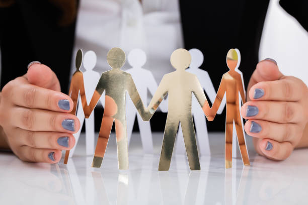 istock Businesswoman Hand Protecting Cut-out Figures 838507558
