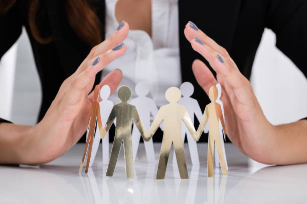 istock Businesswoman Hand Protecting Cut-out Figures 838507576