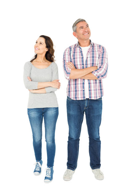 istock Smiling couple with crossed arms looking away 838511002
