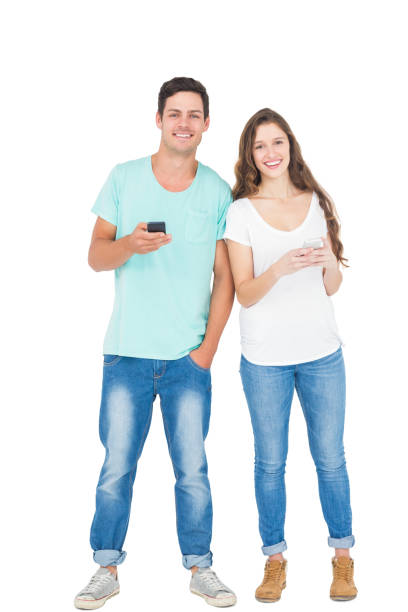 istock Smiling couple using their smartphones 838511354