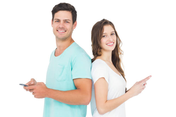istock Smiling couple using their smartphones back to back 838511380