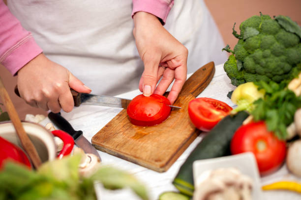 istock Woman cutting tomato for salad 838517868