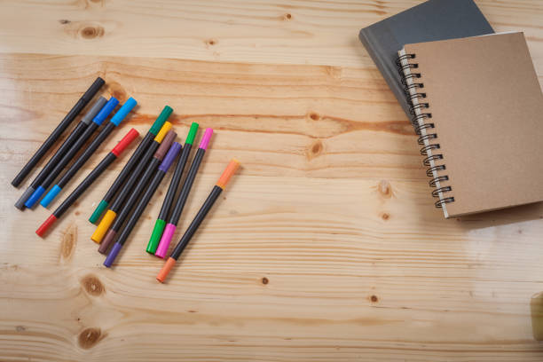 istock color pen on wood table with many equipment. 838520096
