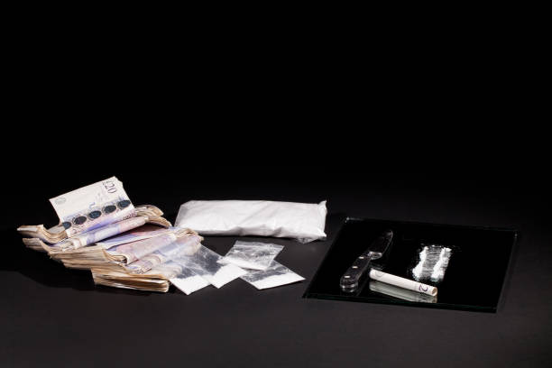 drug dealing. cocaine drugs haul with uk money and a line of coke. - cutting cocaine imagens e fotografias de stock