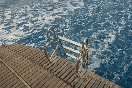 Ship ladder against the sea. Close Up