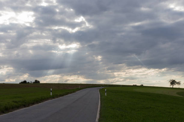 istock road on august summer evening with contrastful cloudy sky 838524008