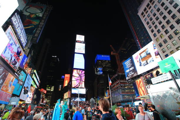 time square New York October 4: crowded people stay in time square at night in New York . time square is the most popular landmark and nightlife area in new york new york marathon photos stock pictures, royalty-free photos & images