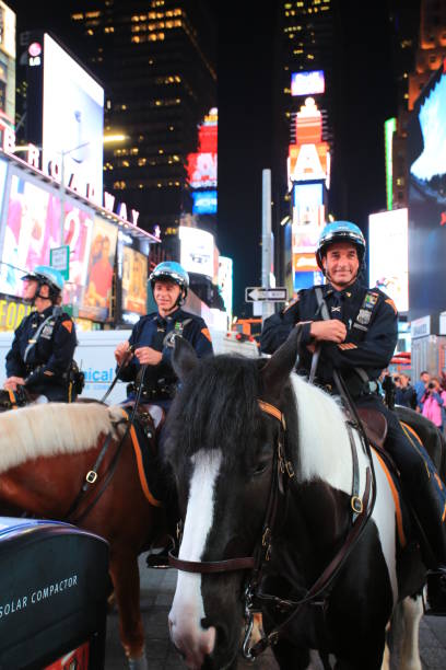 time square New York, USA - October 4 2016:Police force on the horse in the crowd in time square at night in New York . time square is the most popular landmark and nightlife area in new york new york marathon photos stock pictures, royalty-free photos & images
