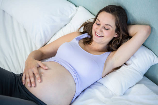 istock Pregnant woman lying in bed 838524898