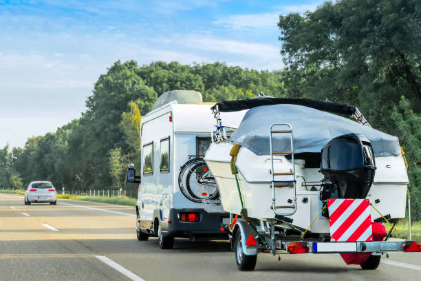 Caravan and trailer for motor boats on road in Switzerland Caravan and trailer for motor boats on the road in Switzerland. trailer stock pictures, royalty-free photos & images