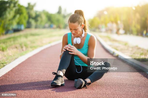 Young Woman Exercising Stock Photo - Download Image Now - Physical Injury, Running, Knee
