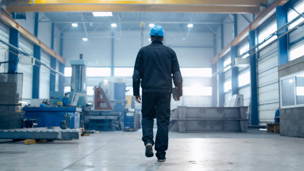 istock Factory worker in a hard hat is walking through industrial facilities. 838527616
