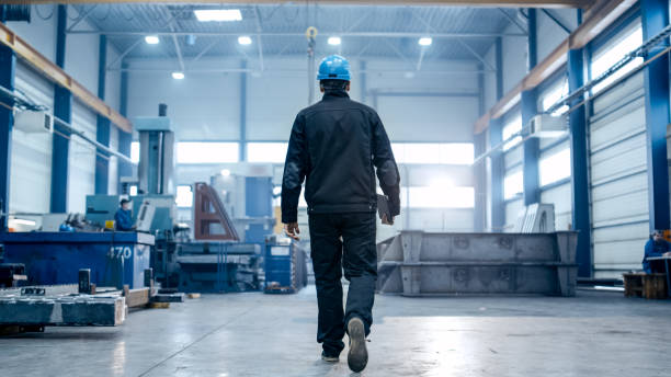 istock Factory worker in a hard hat is walking through industrial facilities. 838527630
