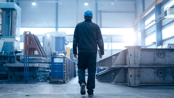 istock Factory worker in a hard hat is walking through industrial facilities. 838527636