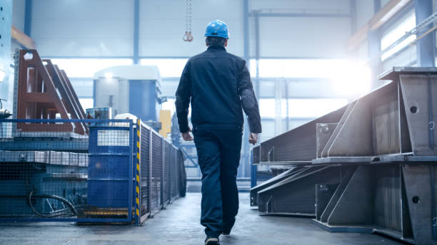 istock Factory worker in a hard hat is walking through industrial facilities. 838527640