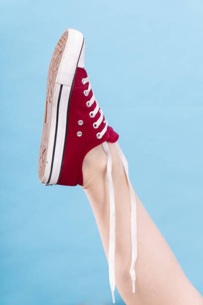 istock Person tying red sneaker with foot up 838527646