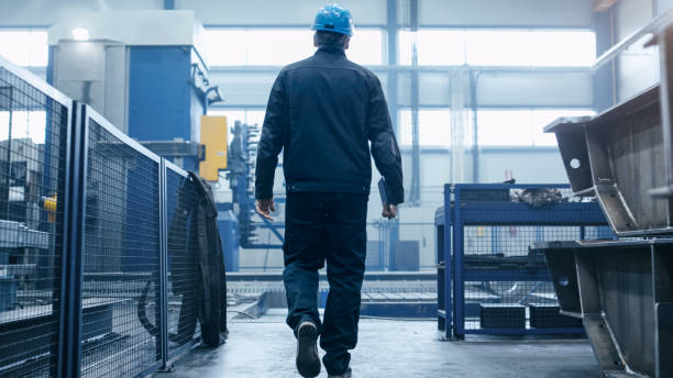 istock Factory worker in a hard hat is walking through industrial facilities. 838527658