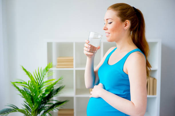 istock Pregnant woman drinking water 838527904