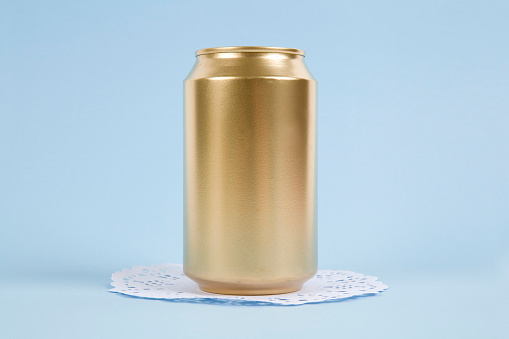 an unused can painted in gold on a virant colored background. Minimal color still life and quirky photography