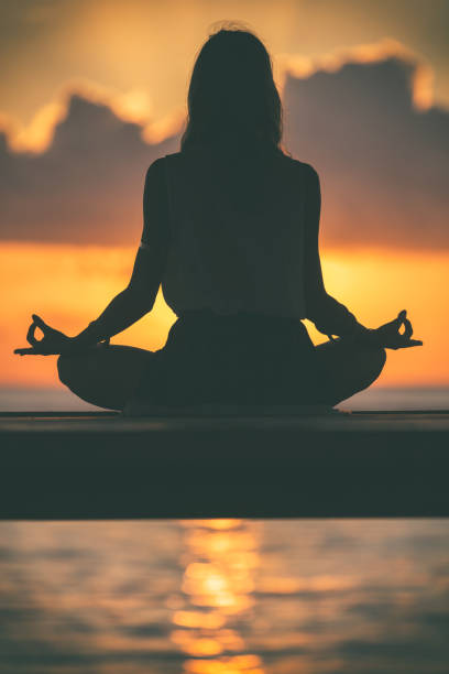 istock Young woman practicing yoga on the beach. 838528530