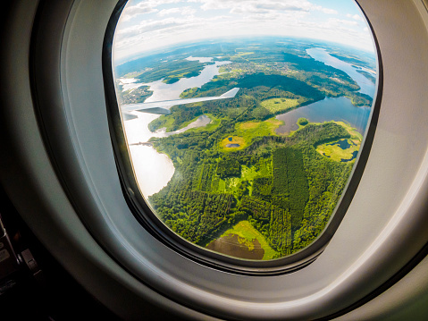 View through the porthole during the flight from South Korea to Russia. Shot with Olympus OM-D E-M1. Fish-eye lens.