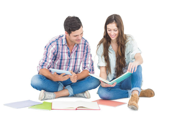istock Happy couple studying with books and tablet while sitting on the floor 838544764