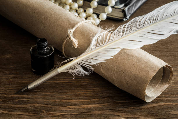 istock Old quill pen on the old paper scroll. Letter writing. Historical atmosphere. 838545234