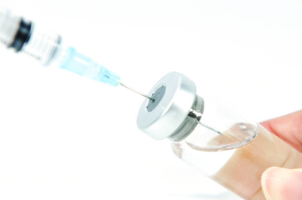 istock syringe needle in vial with vaccine 838549508