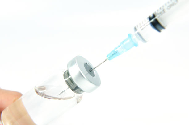 istock syringe needle in vial with vaccine 838549652