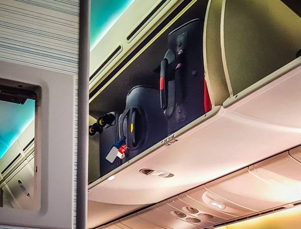 istock Luggage in the overhead compartment inside the plane 838551530