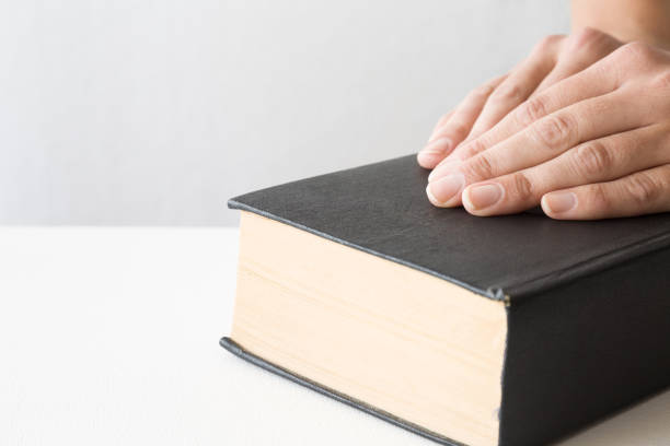 istock Woman's hands on the old, thin book. Quiet, light atmosphere. 838556910